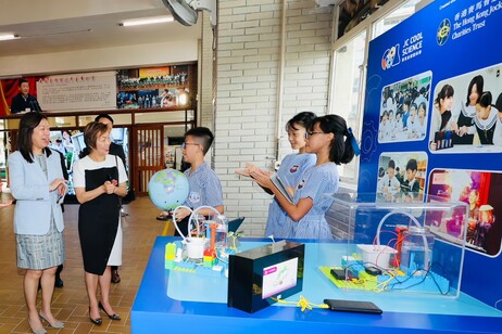 试行伙伴学校学生向嘉宾（左一：教育局常任秘书长陈颖韶、左二：香港赛马会董事龚杨恩慈）分享实践经验及展示成果