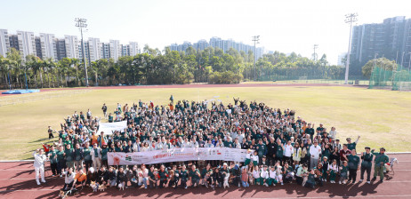 Participants and their dogs join for a group photo, showcasing people pet inclusion and a spirit of community care