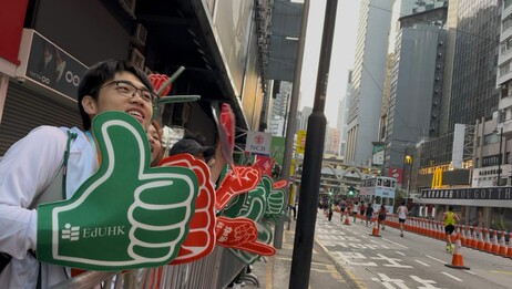 EdUHK cheering team chants and waves props to support the runners