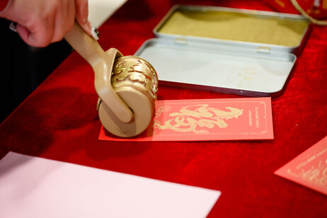 Students print festive Lai See envelopes with golden patterns