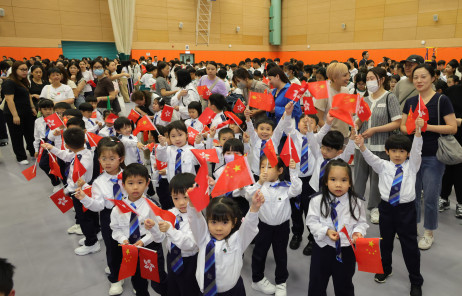 Students from different districts, together with parents and teachers, take part in the flag-raising ceremony