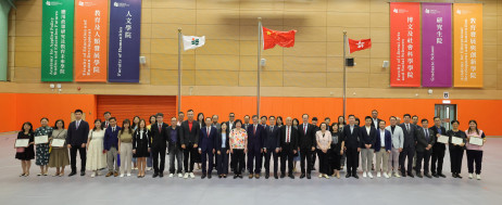 Guests and district school representatives pose for a group photo at the flag-raising ceremony
