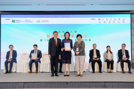 Ms Imma Ling, accompanied by Professor John Lee, presents a certificate of appreciation to Ms Brenda Ng