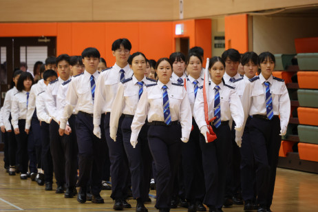 教大學生升旗隊手持中華人民共和國國旗、香港特區區旗及教大校旗整裝列隊進場