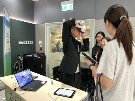 A participant experiences an immersive learning environment with a VR headset